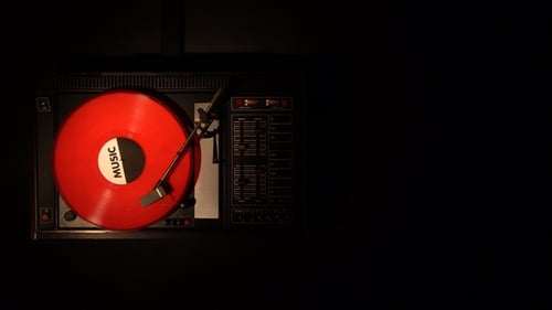 A Record Player Turntable with It's Stylus Running Along a Vinyl Record