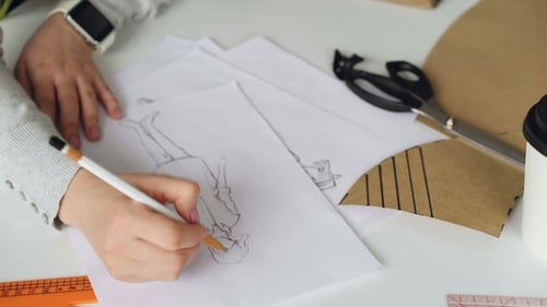 Young Woman Fashion Design at Desk