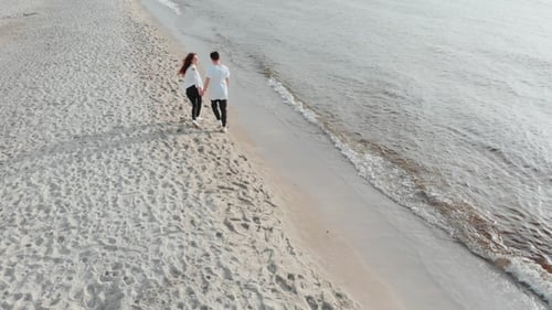 Aerial Drone View Above Couple in Love Walking on Sandy Sea Beach. Pair Are in Love, Having Good