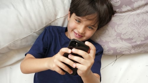 Junge spielt Spiel am Telefon