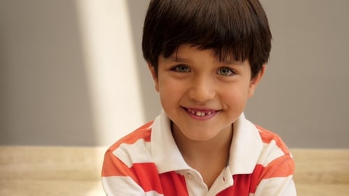Smiling Boy with Striped Shirt Looking at Camera