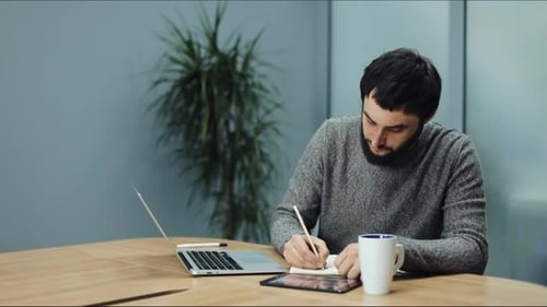 Man Takes Notes From His Laptop To His Laptop