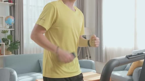 Man Working Out on Treadmill at Home