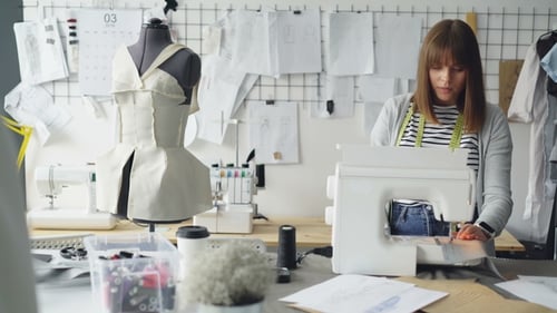Woman Sewing Fashion in Studio