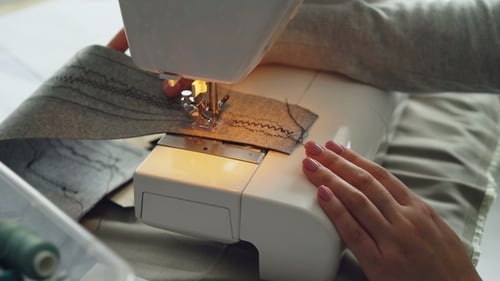 View of Modern Electric Sewing Machine Working Stitching Piece of Fabric