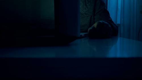 Young Adult Working on a Computer at Night