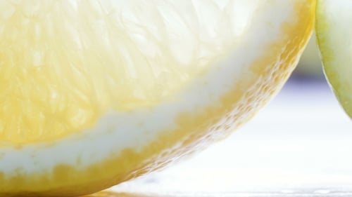 Footage of Camera Panning Along Lemon, Lime and Orange Slices on Table