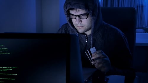 Footage of Hacker Working at Night. Man in Hood Stealing Money From Credit Card