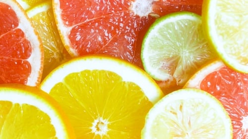 View From Top of Camera Panning Along Assortment of Citrus Slices Lying on Table