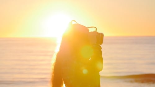Young Woman Uses a Virtual Reality Glasses at Sunset