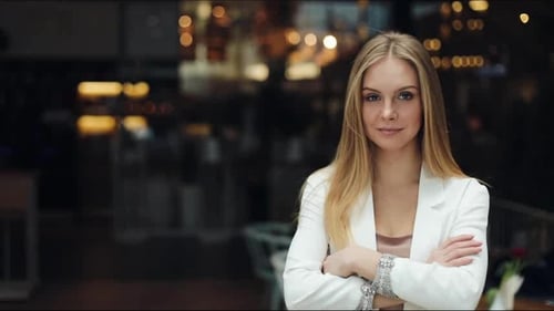 Confident Woman Poses Elegantly with Arms Crossed