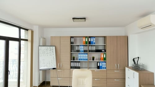 Empty Modern Office with a Desk with Laptop and Papers on It