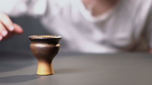 Hookah Bowl Close-up with Man's Hand
