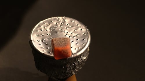 Burning Hot Charcoals Piled on Foil Bowl