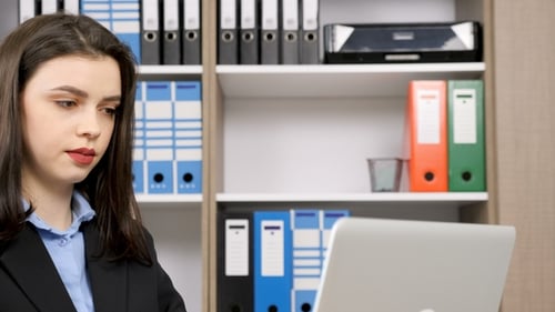 Professional Woman Working at Laptop in Office