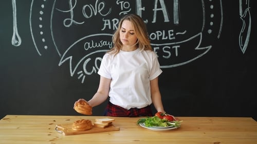 Woman Choosing Healthy Salad Over Bread and Rolls