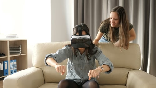 Woman with VR Headset Plays with Friend