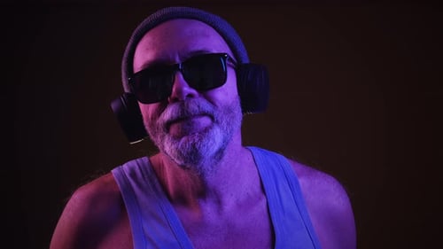 Man with Gray Beard Dancing with Headphones