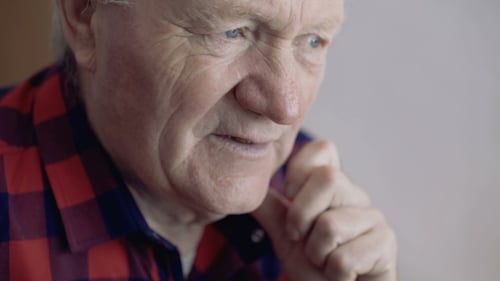 Portrait of Old Man Looks at Window with Thinks Then Turns at Camera