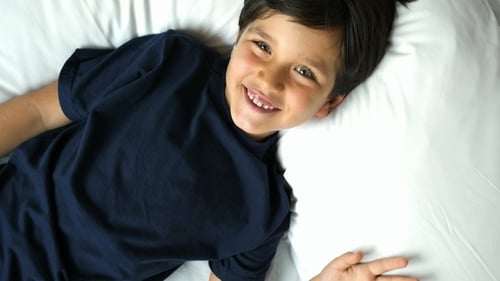 Boy Lying and Laughing