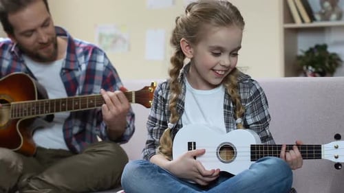 Father and Daughter Play Music Together at Home