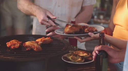Man Cooking BBQ Meat on Grill