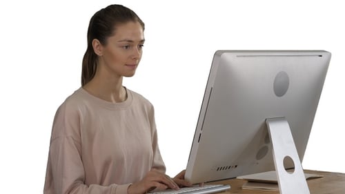 Woman Typing on Computer in Bright Office