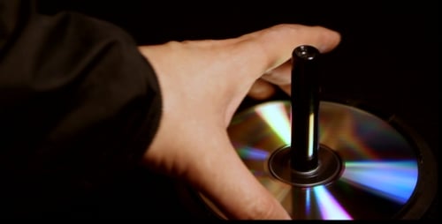 Compact Discs Stacked on Black Background Close Up