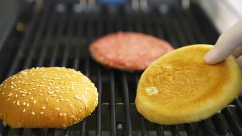 Chef cooking meat burger. Chef prepares fast food at the restaurant