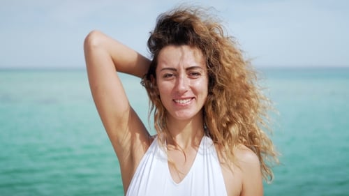 Portrait of Beautiful Young Woman. Blowing in Wind on Tropical Beach