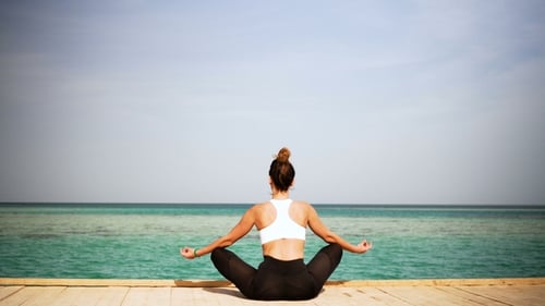 The Girl Is Making Yoga Pose on Beach of the Island. Static. Sea or Ocean Happy Woman Relaxation