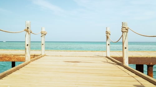 Walking on the Pier. Sea and Sky in the Background