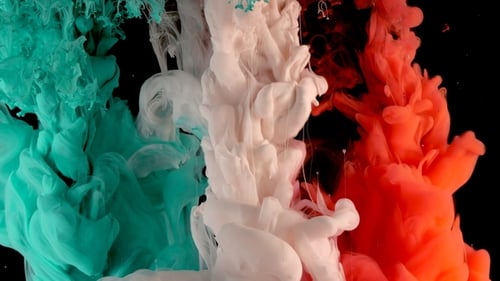 Green, White and Red Ink in Water Shooting with High Speed Camera. Paint Dropped, Reacting, Creating