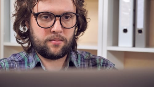 Bearded Guy Close a Laptop Posing with Smile