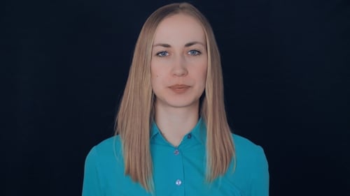 Smiling Woman Gives OK Hand Gesture