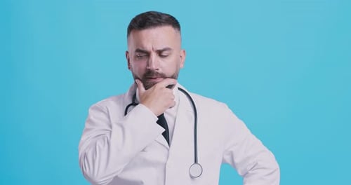 Studio Portrait of Thoughtful Medical Doctor Thinking Over Problem Solution