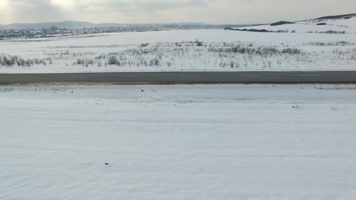 Aerial Shot of Trucks Driving on a Road on Winter Sunny Day