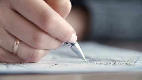 Hand of Female Drawing at Paper in Her Studio. Woman's Hand Draws a Pencil.