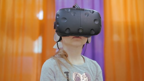 Virtual Reality Helmet. A Man Wearing Glasses Vr, a Headset, Playing a Virtual Game and Watching a