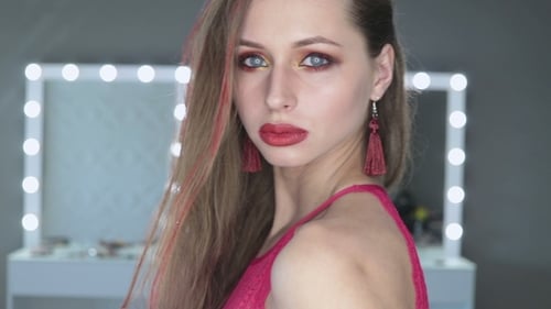 Glamorous Woman Posing with Dramatic Makeup in Studio