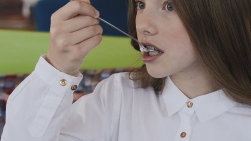 Girl Eating Cake with Spoon, Close Up