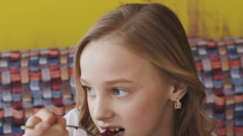 Charming Child Eating Dessert Indoors Close Up