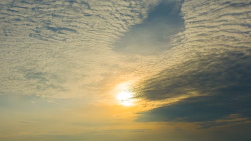 Dramatic Clouds Float in Golden Hour Sky