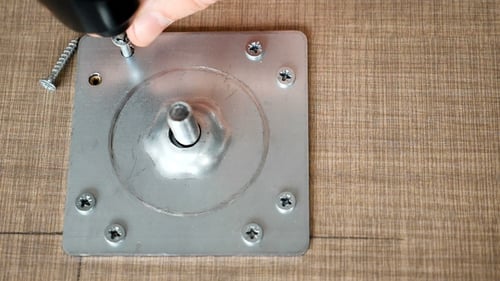 Man Is Screwing a Screw in the Place for Furniture Assembling