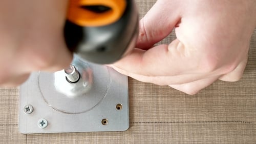 Man Assembling a Desk Leg
