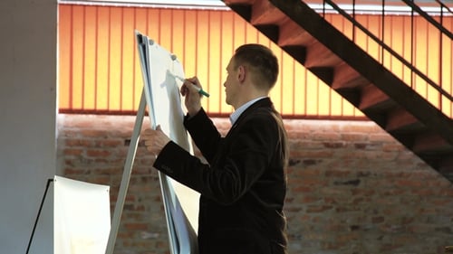 Man Drawing on Whiteboard in Modern Office