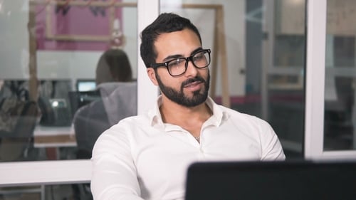 Friendly Man Talking in Modern Office Setting