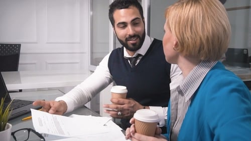 Office Workers Drink Coffee During Discussion