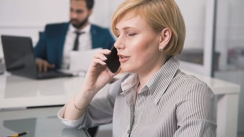 Woman Talks on Phone in Office
