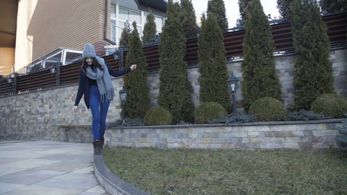 Woman Walking and Balancing in Suburban Yard
